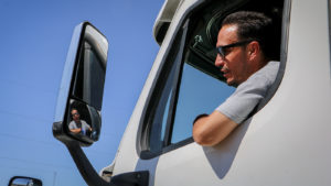 trucker looking in sideview mirror