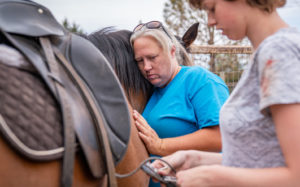Kendra Loring petting a horse