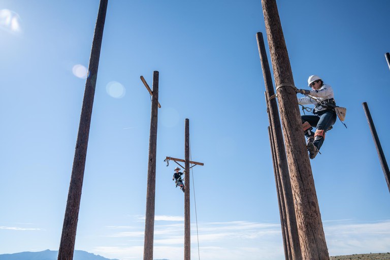 Faith climbing a pole at the Rio Rancho campus.