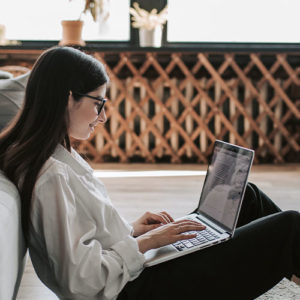 Woman sitting down working on laptop