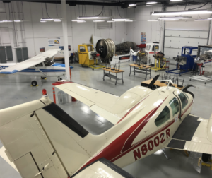 Aviation classroom in a hanger with various airplanes and airplane components