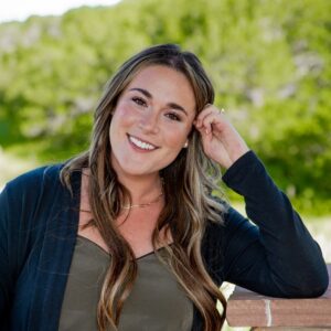 Katie Vadurro sitting outside for a headshot photo